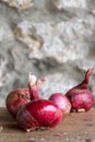 Close-up of a group of purple onions on wooden table