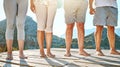 Close up of a group of seniors feet. Midsection of mature people standing barefoot in a row against a mountain view