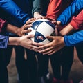 Close-up of a group of soccer players holding a ball.