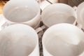 Close-up of a group of white ceramic tea cups and plates standing on a table with a white tablecloth, clean dishes in the hotel Royalty Free Stock Photo