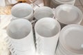 Close-up of a group of white ceramic tea cups and plates standing on a table with a white tablecloth, clean dishes in the hotel Royalty Free Stock Photo