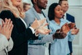 Close up. a group of young business people giving a standing ov Royalty Free Stock Photo