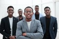 Group of young business people standing in the office lobby. Royalty Free Stock Photo