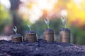 Close up growing small plant on coins money on green bokeh background Royalty Free Stock Photo