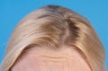 Close up grown natural roots of colored blonde hair. Shiny and healthy beautiful hair. Healthy and wellness concept