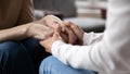 Close up grownup daughter comforting, holding mature mother hands Royalty Free Stock Photo