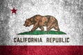 Close-up of the grunge California state flag. Dirty California state flag on a metal surface