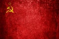 Close-up of the grunge flag of the Soviet Union. Dirty USSR flag on a metal surface