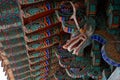 Close up of guardian colorful dragon. Colorful roof decoration of a buddhist temple. Wooden dragon with open mouth. Bulguksa close