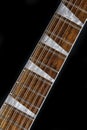 Close up of guitar with Chechen wood fretboard and unique triangular pearl inlays Royalty Free Stock Photo