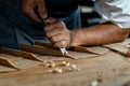 Close-up of guitar luthier using chisel to shave bracing of acoustic guitar