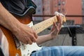 Close-up of the guitar player playing guitar during the open air concert.