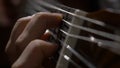 Close up of guitarist hand playing acoustic guitar. Close up shot of a man with his fingers on the frets of a guitar Royalty Free Stock Photo