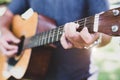 Close up of guitarist hand playing guitar. Musical and instrument concept. Outdoors and Leisure theme. Selective focus on left ha Royalty Free Stock Photo