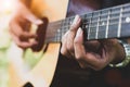 Close up of guitarist hand playing guitar. Musical and instrument concept. Outdoors and Leisure theme. Selective focus on left ha Royalty Free Stock Photo