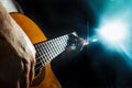 Close-up of guitarist right hand playing on classical guitar. Musical stage concert lighting Royalty Free Stock Photo