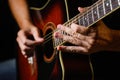 Close-up of a guitarist\'s hands. An experienced guitarist plays the acoustic guitar.