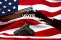 Guns with the letters vote in front of the American flag Royalty Free Stock Photo