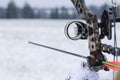 Close-up Gunsight on the hunting bow. Winter season and snowy landscape