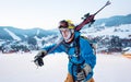 Close-up skier holding sticks on his shoulder of ski resort