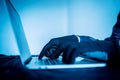 Close up hacker hand typing keyboard input code for register system structure or unlock password on laptop in darkness operation Royalty Free Stock Photo