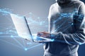 Close up of hacker hands using laptop with creative glowing polygonal interface on blurry background. Technology, hacking, malware Royalty Free Stock Photo