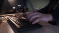 Close-up of hacker typing on keyboard. Stock footage. Programmer quickly typing code or text on computer keyboard. In Royalty Free Stock Photo