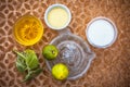 Close up of hair mask for the treatment of aggravated scalp on brown colored surface i.e. yogurt,,honey and lemon juice in a glass