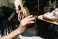 Close-up of a hairdresser cutting the hair of a woman in a beauty salon Royalty Free Stock Photo