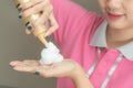 Close-up of hairdresser hairstylist female hand with hair mousse spray