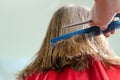 Close up of hairdresser hands cutting brown hair at home. Professional stylist trimming hair split ends Royalty Free Stock Photo