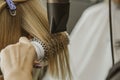 Close up of hairdresser hands drying human hair with equipment. Woman holding a comb. close-up. Macro photo Royalty Free Stock Photo