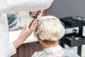 Close up of hairdresser`s hands are combing client`s hair at beauty salon Royalty Free Stock Photo