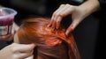 close-up of a hairdressers hands applying hair dye to a c generative AI