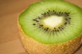 Close up of a half kiwi. Wooden background