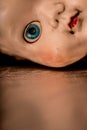 Close up of old neglected and unloved plastic doll . Royalty Free Stock Photo