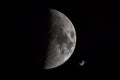 Close-up of half moon in the night sky with passing orbital space station ISS Royalty Free Stock Photo