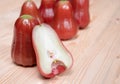 Close up half rose apple on the wooden table