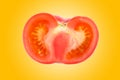 Close up of a half sliced fresh, organic red tomato on a vibrant orange gradient background Royalty Free Stock Photo