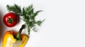 Close-up of half yellow bell pepper, red tomato and dill on white background with copy space. Royalty Free Stock Photo