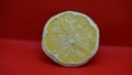 Close-up of halved lemon on red shelf background