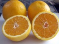 Close-Up of a Halved Orange and Two Whole Oranges Royalty Free Stock Photo