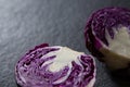 Halved red cabbage on black background