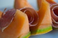 Close-up of ham and slides of orange melon