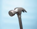 Close-up Hammer construction nail puller on a blue background. Imitation of hammering nails. Construction or renovation concept. Royalty Free Stock Photo