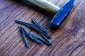 Close-up of hammer and nails on wooden table Royalty Free Stock Photo