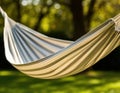 Close-up of a hammock fabric gently blowing in the wind with trees in the background. Royalty Free Stock Photo