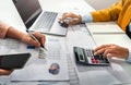 close up hand accountant holding pen pointing on paperwork chart for meeting team in office room. concept finance and accounting Royalty Free Stock Photo