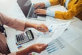 close up hand accountant holding pen pointing on paperwork chart for meeting team in office room. concept finance and accounting Royalty Free Stock Photo