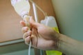 Close up hand adjust saline IV drip for patient in hospital Royalty Free Stock Photo